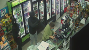 Masked thieves armed with axe and machete threaten shopkeeper